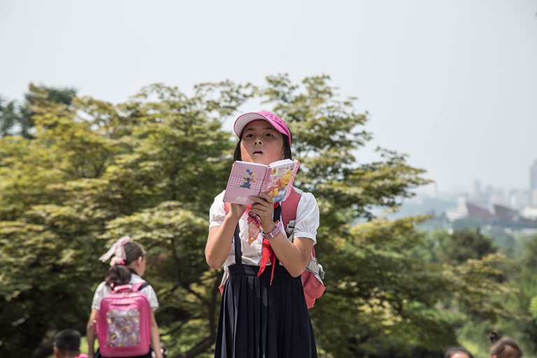 Inside Pyongyang’s Moranbong Park, a Young Pioneer intently taking notes—about what, I’m not sure.